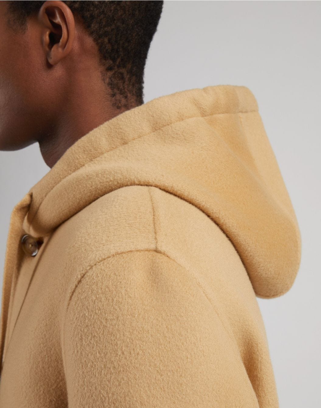 Single-breasted beige wool coat with a hood and drawstring